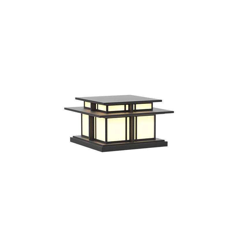 On a plain white backdrop, this Clérachic pillar light displays frosted glass panels beneath a flat aluminium roof.