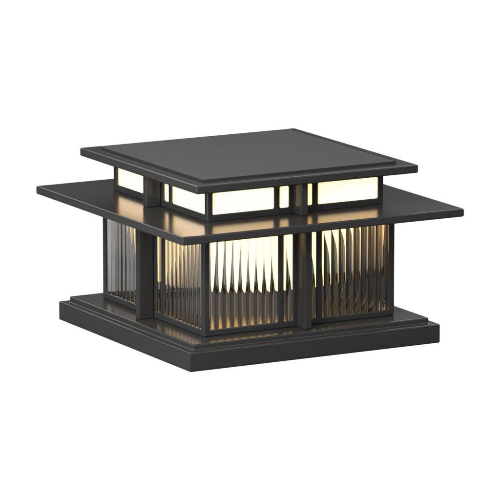 Unlit, this Clérachic pillar light stands on a white backdrop, its fluted glass panels set between dark frames.