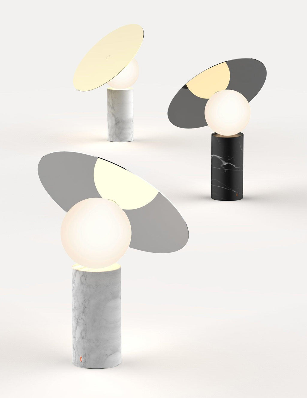 Two Clérachic tilting disc lamps rendered side by side on a plain background, comparing the white marble and black marble bases.