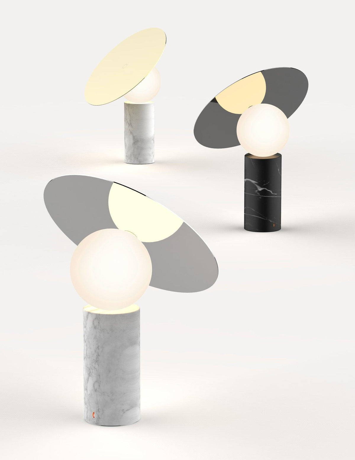 Two Clérachic tilting disc lamps rendered side by side on a plain background, comparing the white marble and black marble bases.