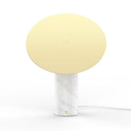 Clérachic tilting disc lamp on a plain white background, shown from an angle where the flat gold panel hides the glass globe behind it.