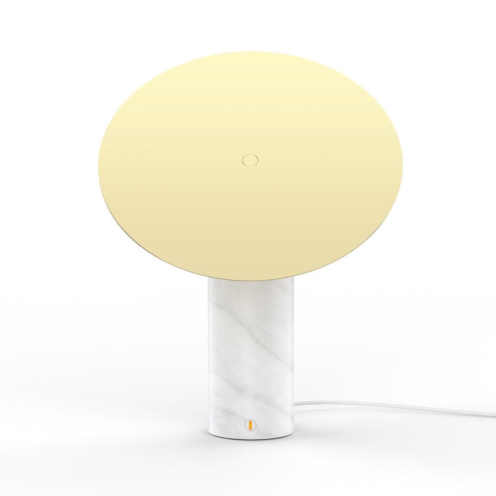 Clérachic tilting disc lamp on a plain white background, shown from an angle where the flat gold panel hides the glass globe behind it.