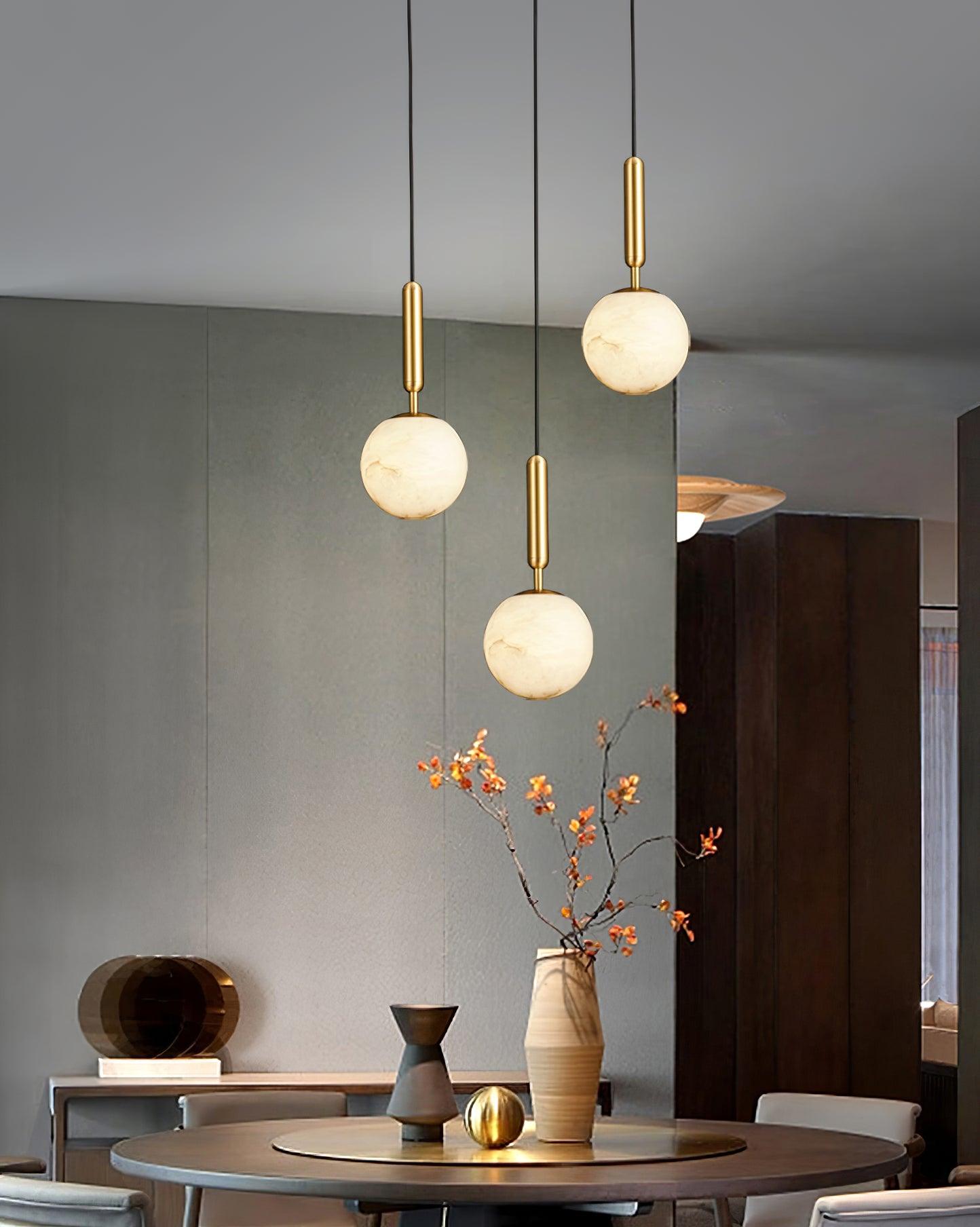 A single pendant lit in a green panelled bedroom, above a tufted headboard and curtains.