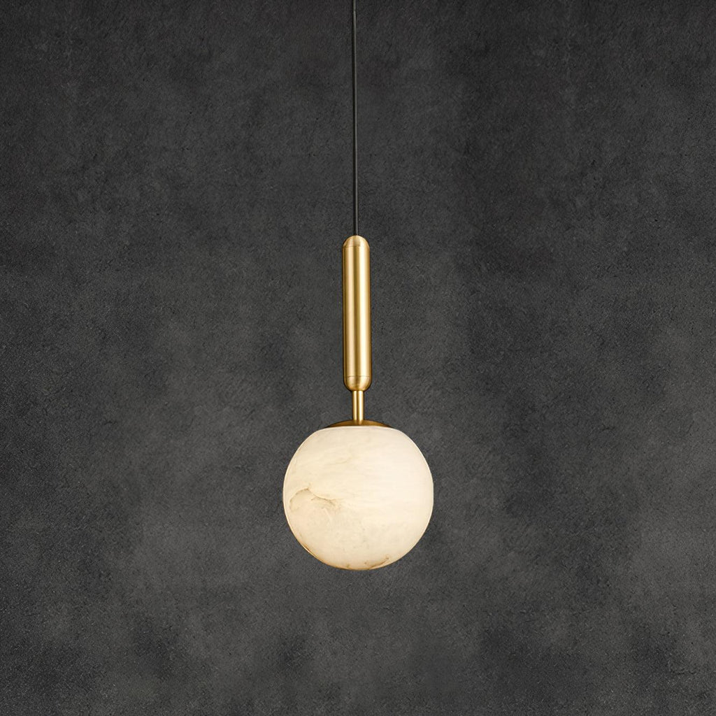 Alabaster globe pendant on a brass stem, hung on a black cord against a dark grey wall.