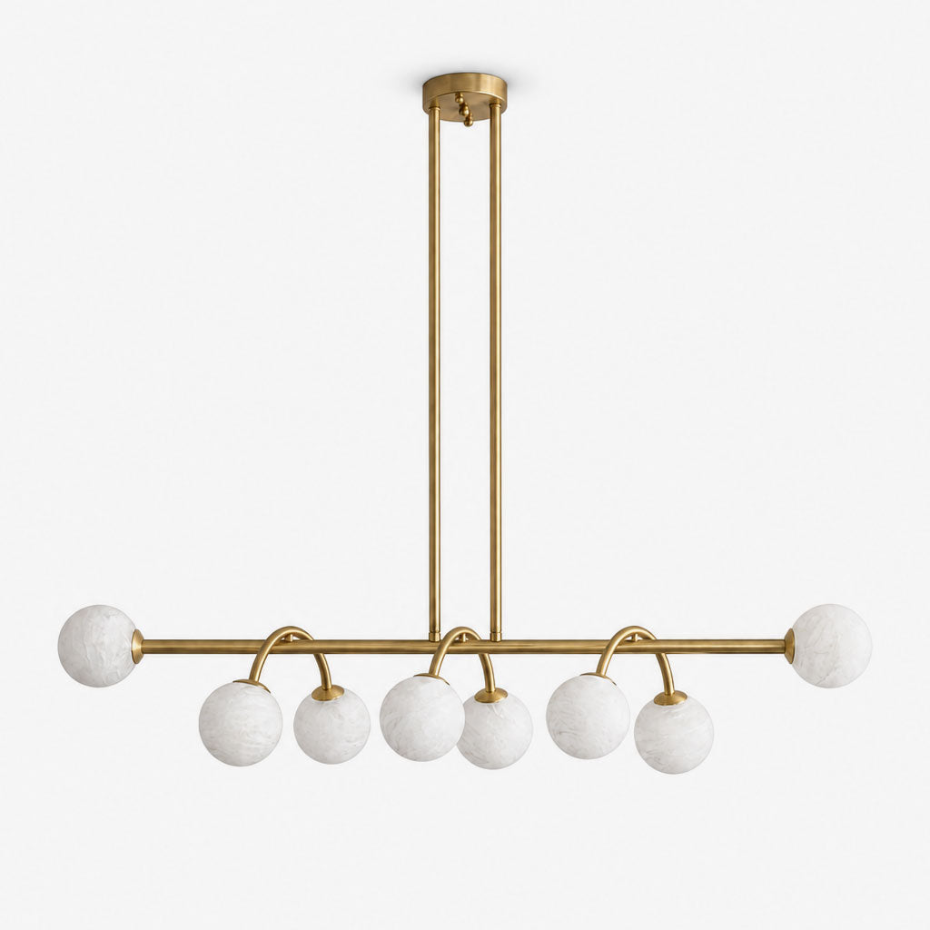 Side view of this Clérachic chandelier in brushed brass, alabaster balls bookending a bar on curved drop arms.