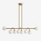 Side view of this Clérachic chandelier in brushed brass, alabaster balls bookending a bar on curved drop arms.