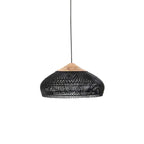 Black woven rattan pendant light glowing softly above a sofa