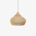 Handwoven natural rattan pendant light against a light wall
