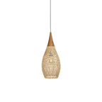 Drum-shaped woven rattan pendant light over a wooden table