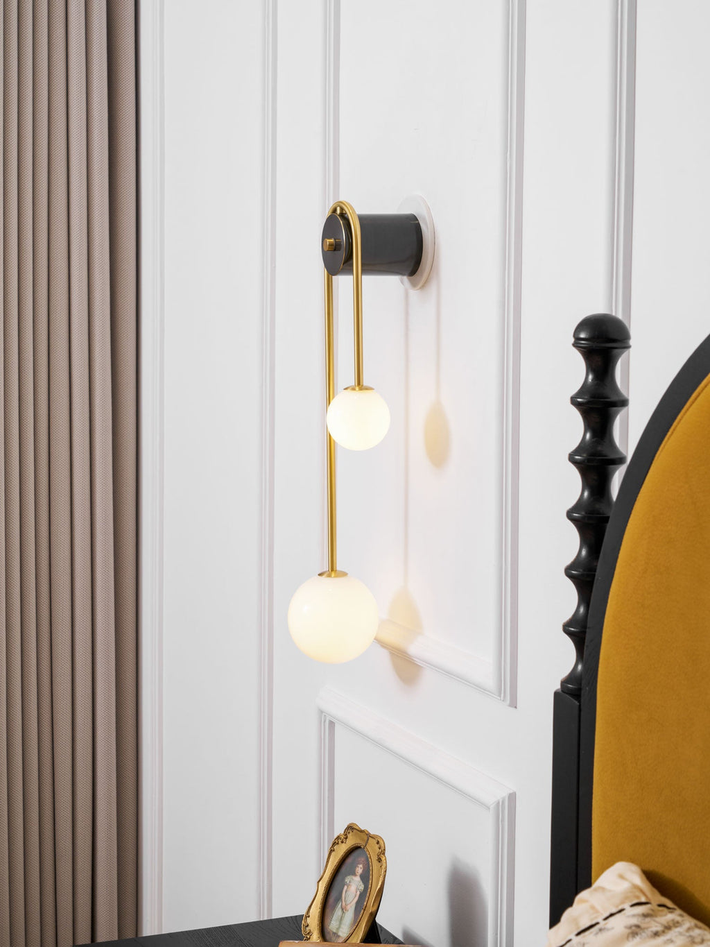 Brass arc wall light detail of the lower white glass shade