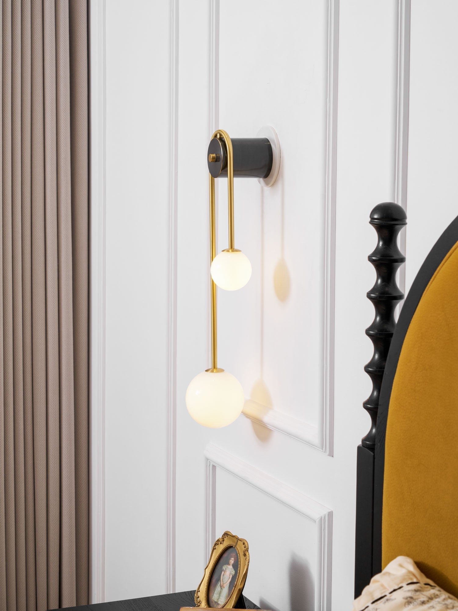 Brass arc wall light detail of the lower white glass shade