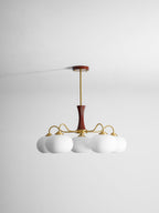 Brass and wood chandelier with white persimmon glass shades