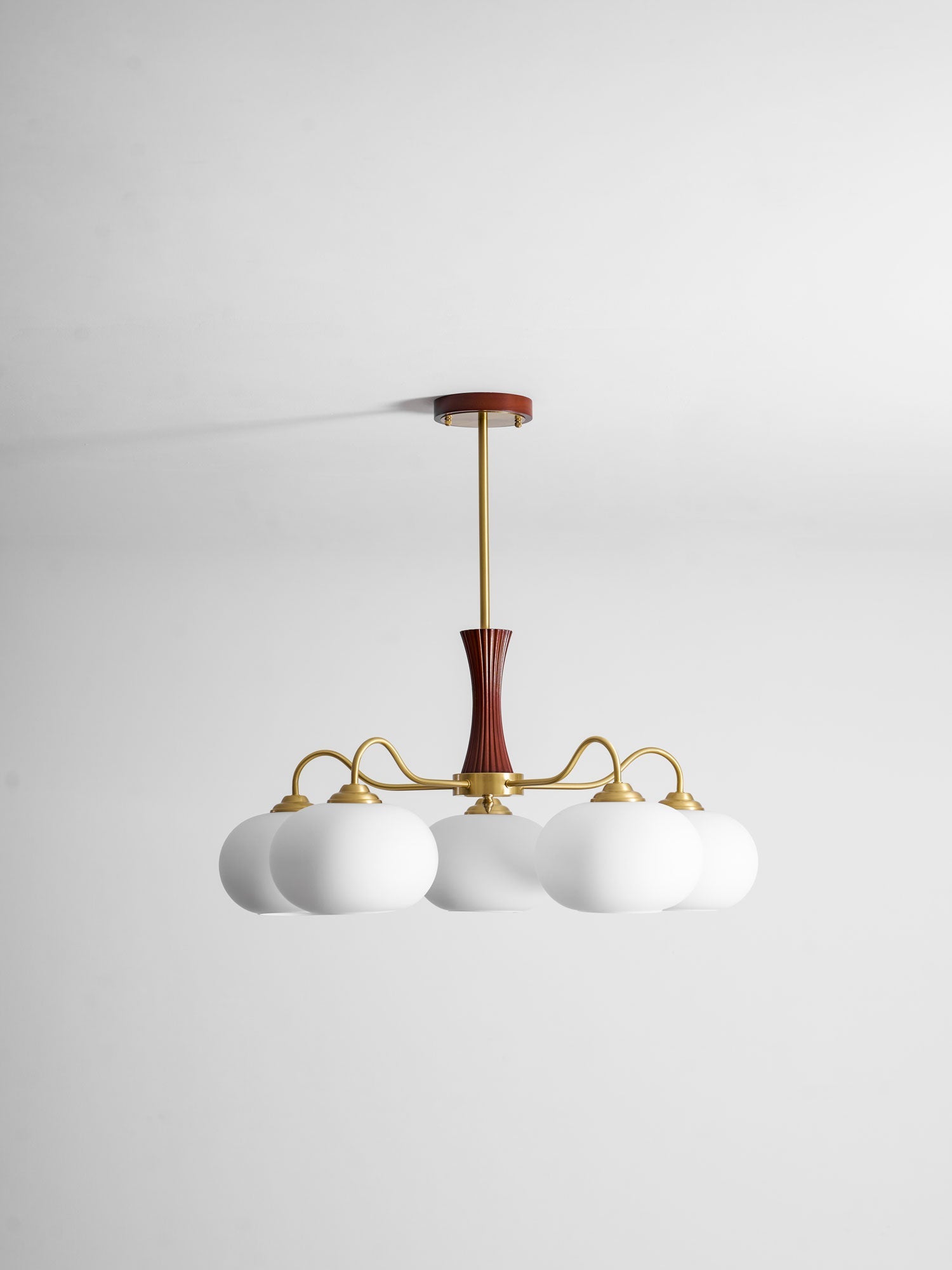 Brass and wood chandelier with white persimmon glass shades