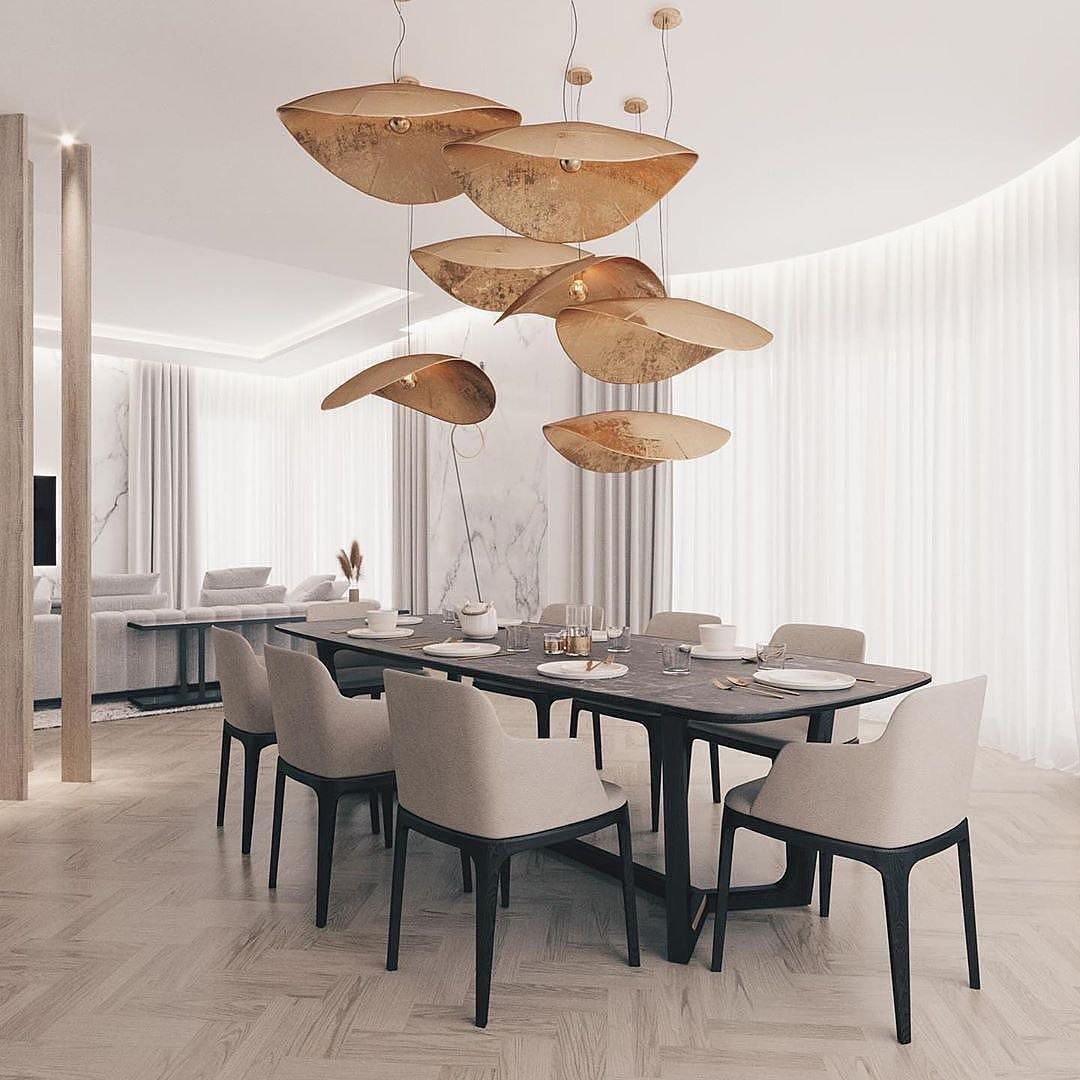 This Clérachic pendant cluster hangs above a set dining table framed by white curtains and columns.