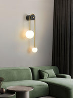 Brass arc wall light mounted near a bedside on the wall
