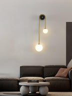 Brass arc wall light with curved arm against a neutral wall