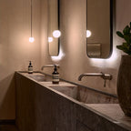 Opal glass globe pendant light shown lit in a calm room