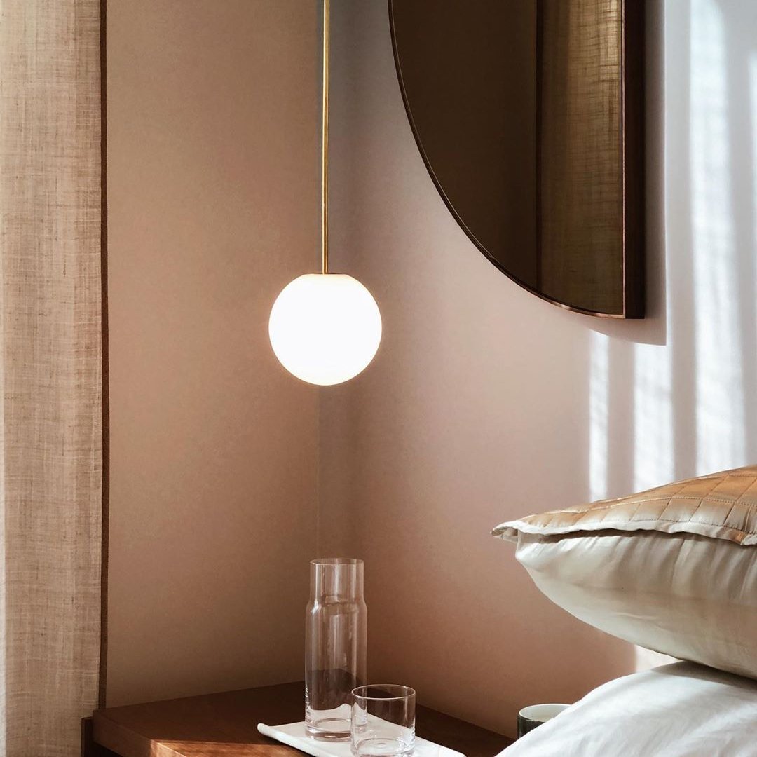 Opal glass globe pendant glowing softly over a table