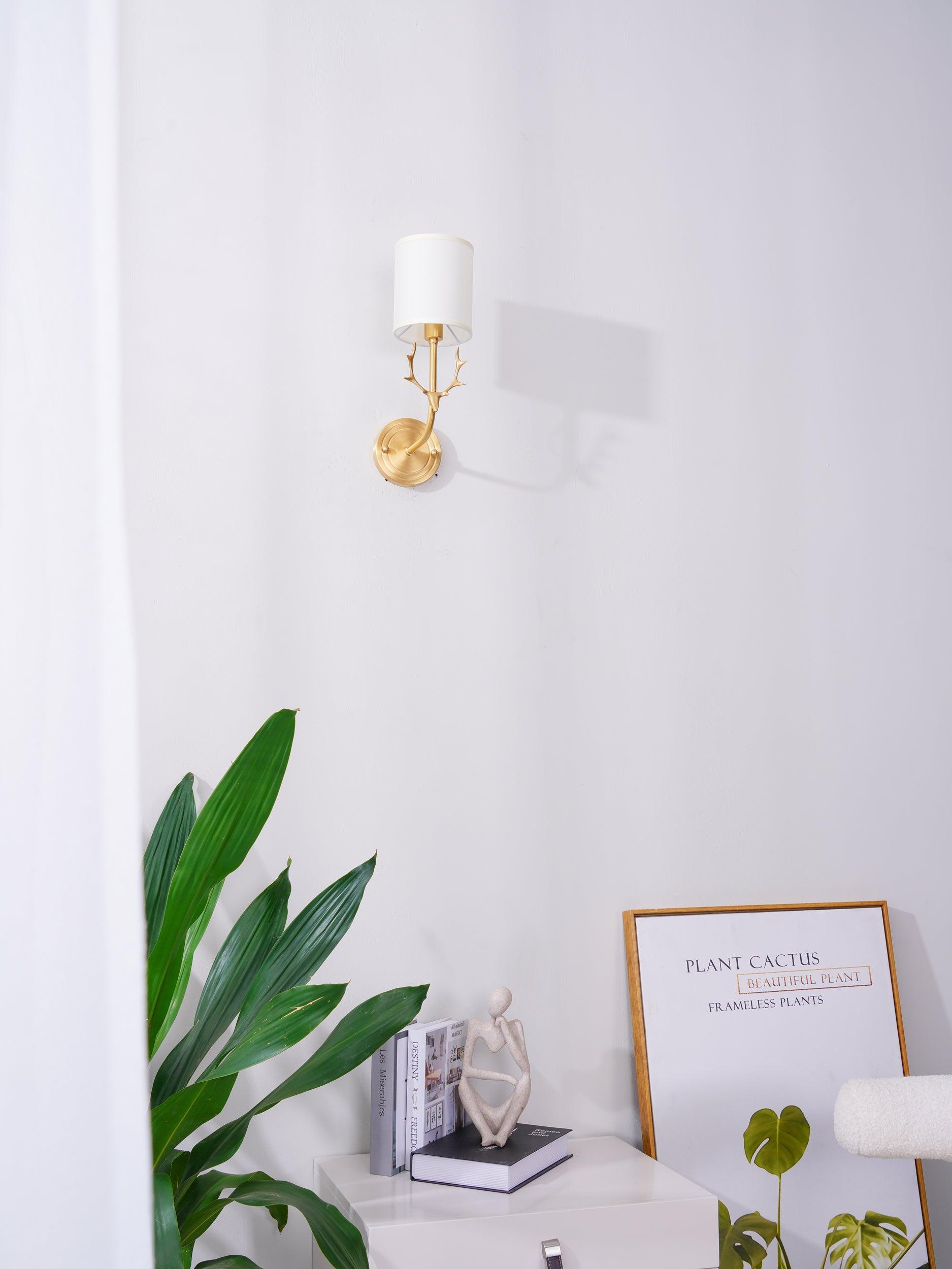 Deer head wall light in brass with circular back panel detail
