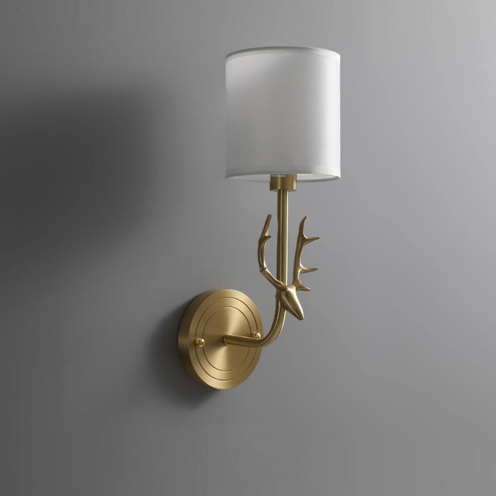Brass deer head wall light detail of antlers and circular panel