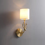 Brass deer head wall light shown against a neutral interior wall