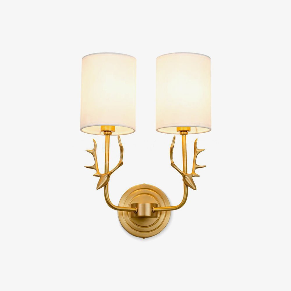 Brass deer head wall light detail showing antlers and linen shade