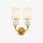 Brass deer head wall light detail showing antlers and linen shade