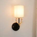 Brass deer head wall light glowing warmly in a styled room