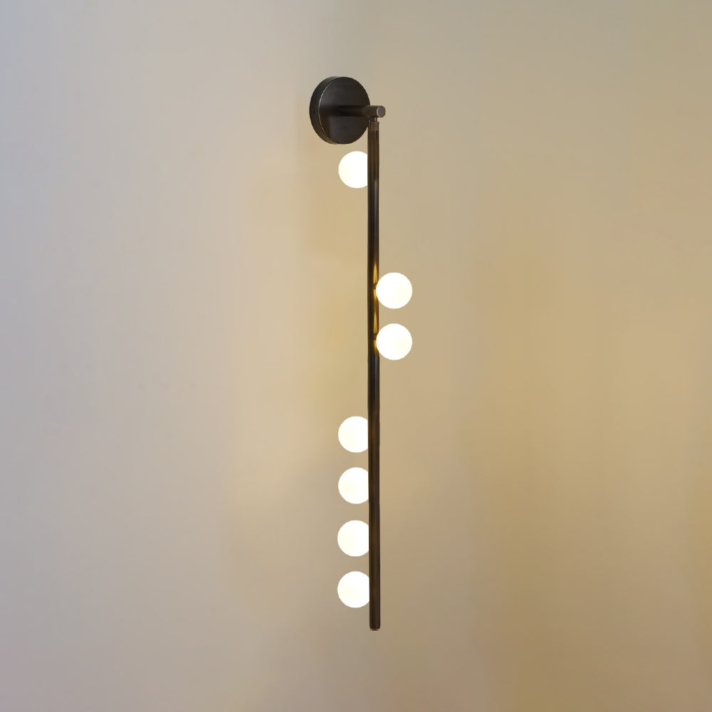 Brass glass tube wall lamp with a cluster of glowing globes