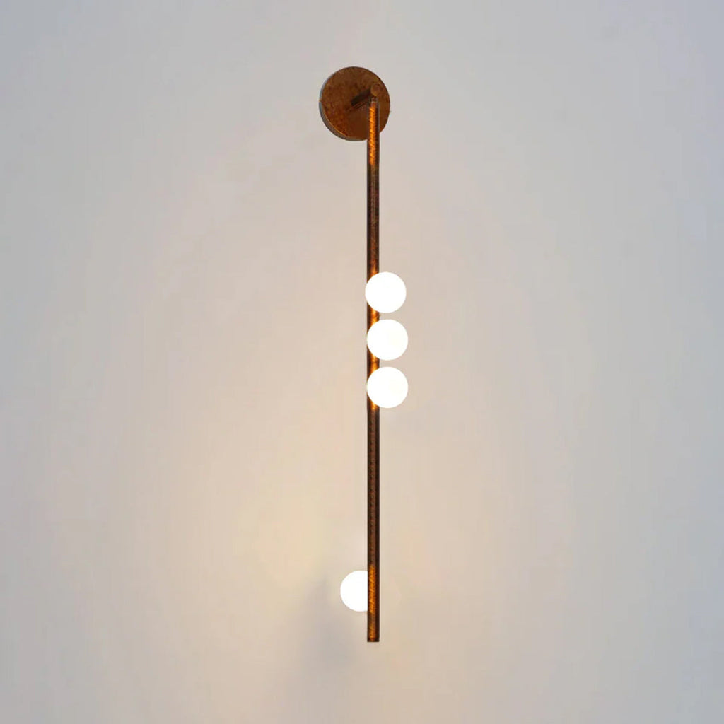 Glass tube wall lamp with hand-blown white globes on brass arms
