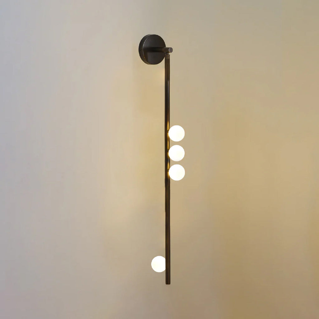 Brass glass tube wall lamp arranged as a vertical column of globes