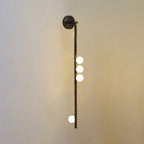Brass glass tube wall lamp arranged as a vertical column of globes
