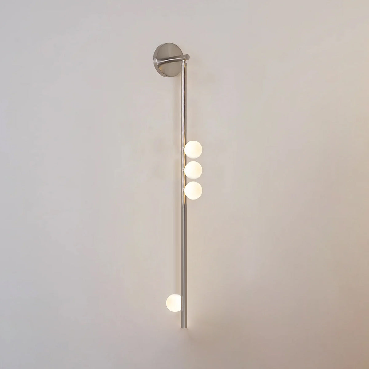 Glass tube wall lamp in brass with warm glowing globe shades