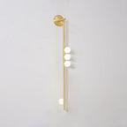 Brass glass tube wall lamp with multiple blown glass orbs lit