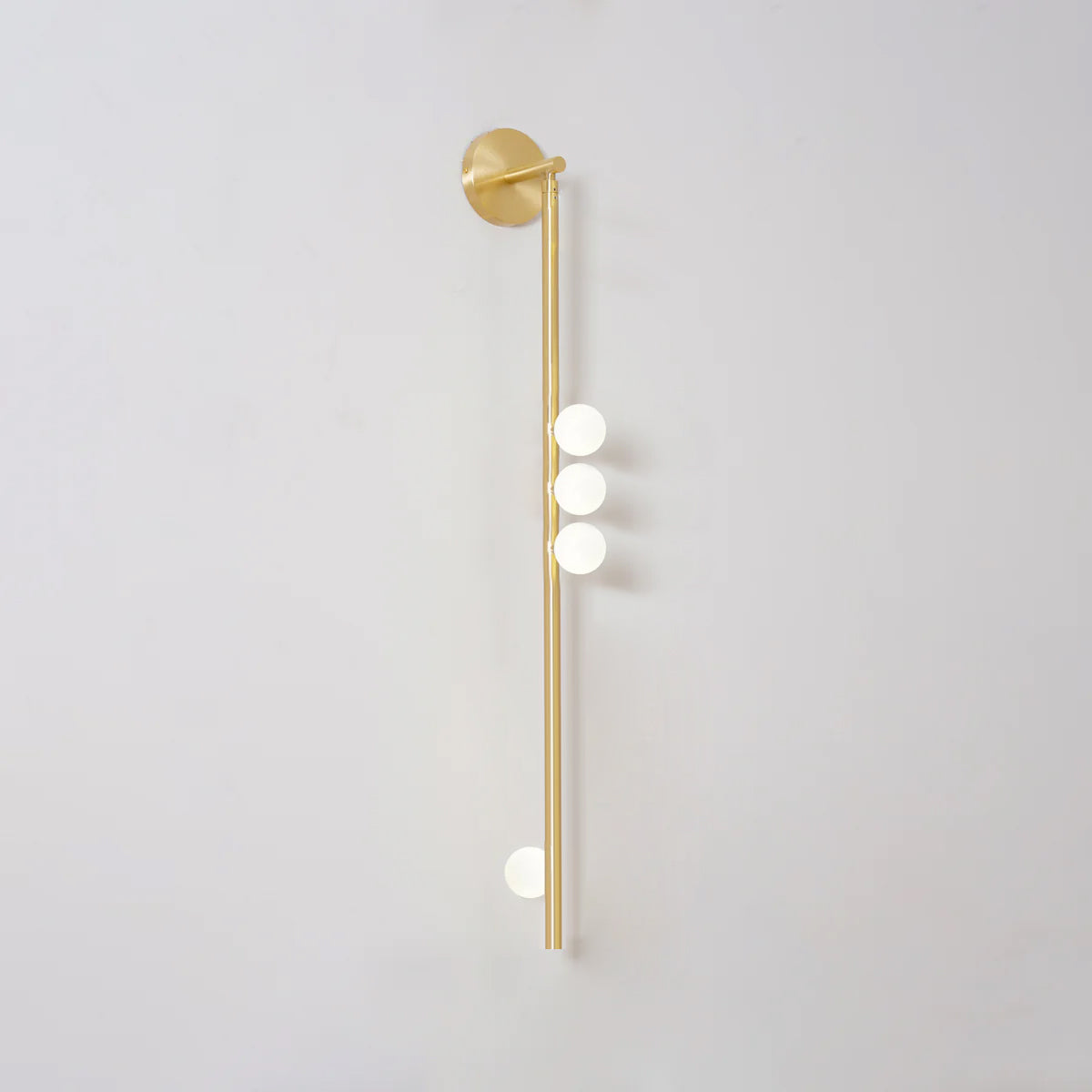 Brass glass tube wall lamp with multiple blown glass orbs lit
