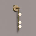 Brass glass tube wall lamp with hand-blown globes glowing warmly