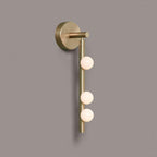 Brass glass tube wall lamp with hand-blown globes glowing warmly