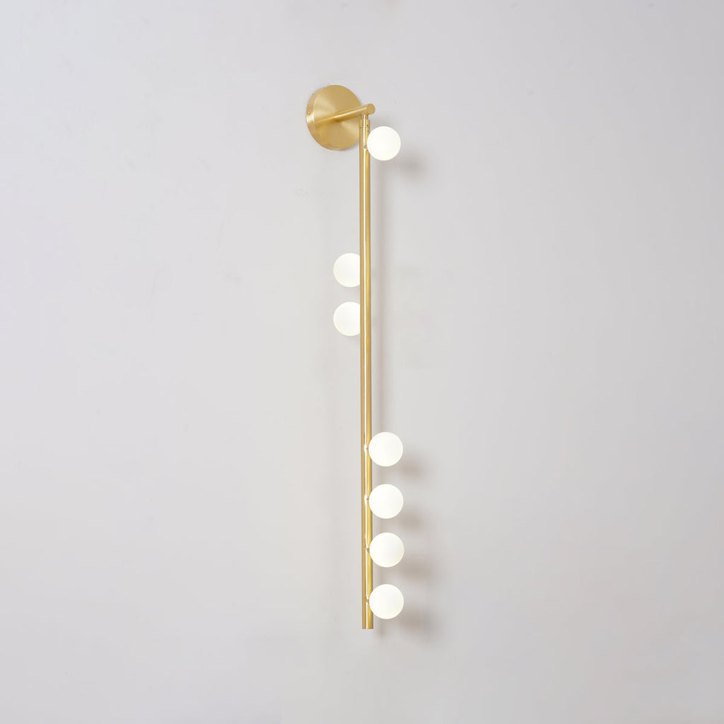 Gold-toned glass tube wall lamp with hand-blown glowing globes