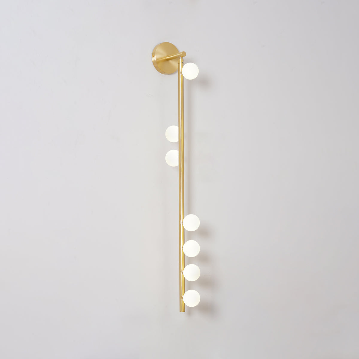 Gold-toned glass tube wall lamp with hand-blown glowing globes