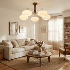 Brass and wood chandelier glowing above a living space