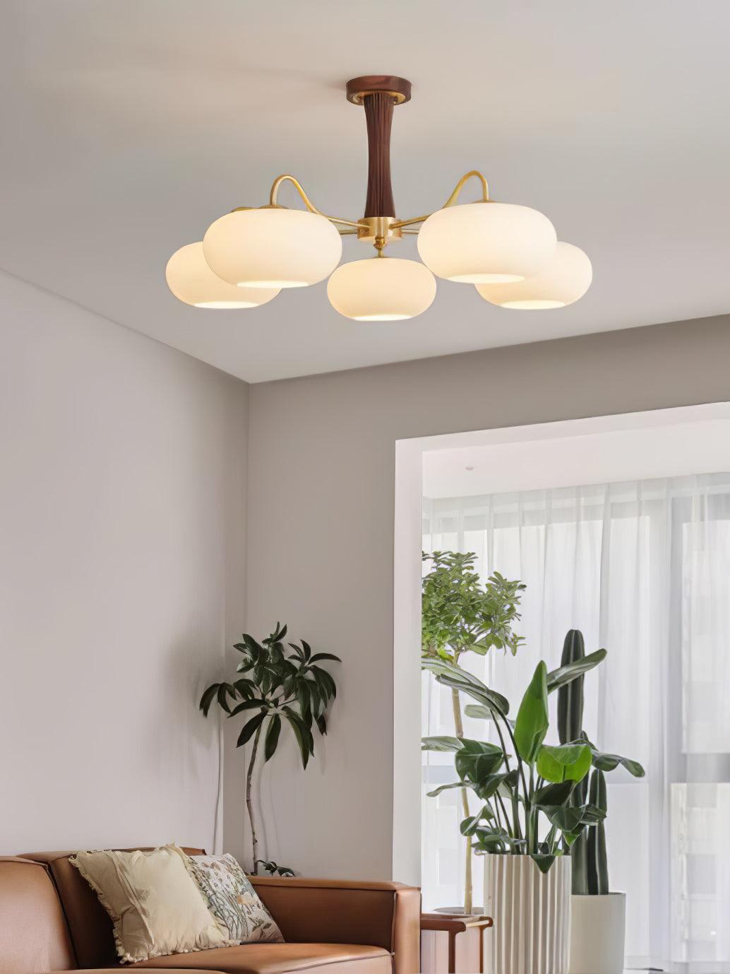 Brass and wood chandelier with persimmon-shaped glass shades