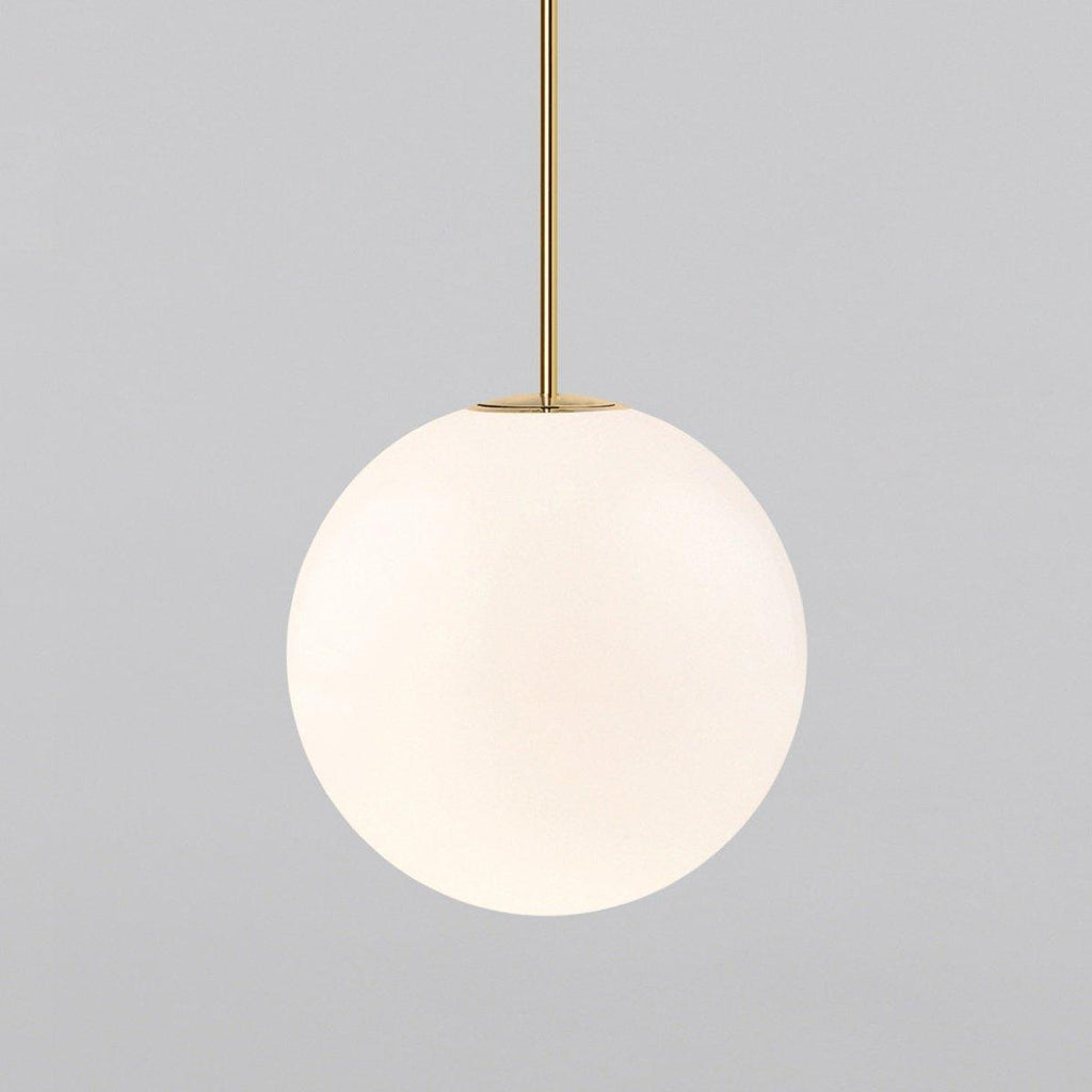 White opal glass globe pendant light against a dark wall
