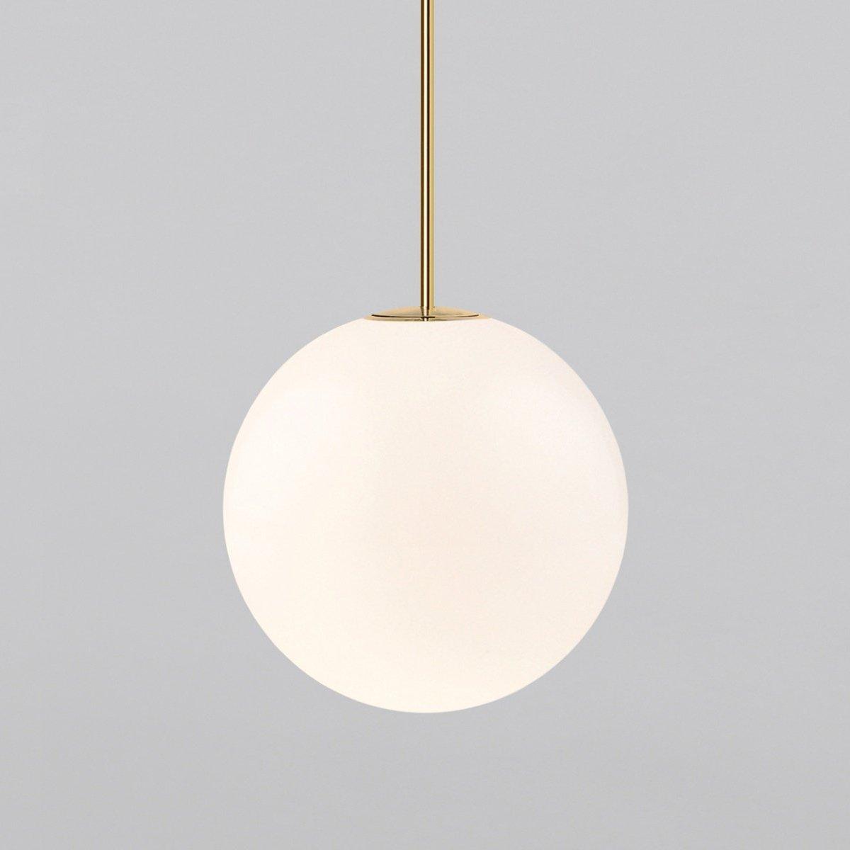 White opal glass globe pendant light against a dark wall