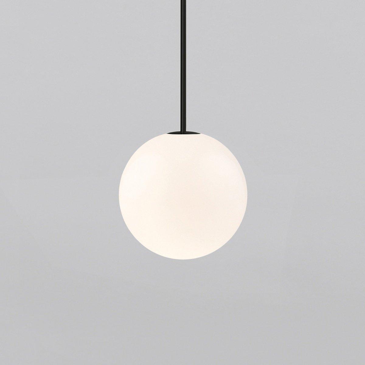 White opal glass globe pendant glowing with warm even light