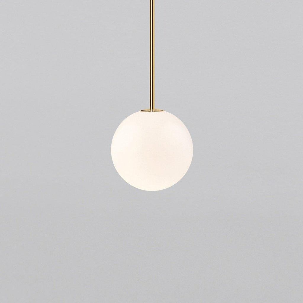 White opal glass globe pendant light on a slim brass rod
