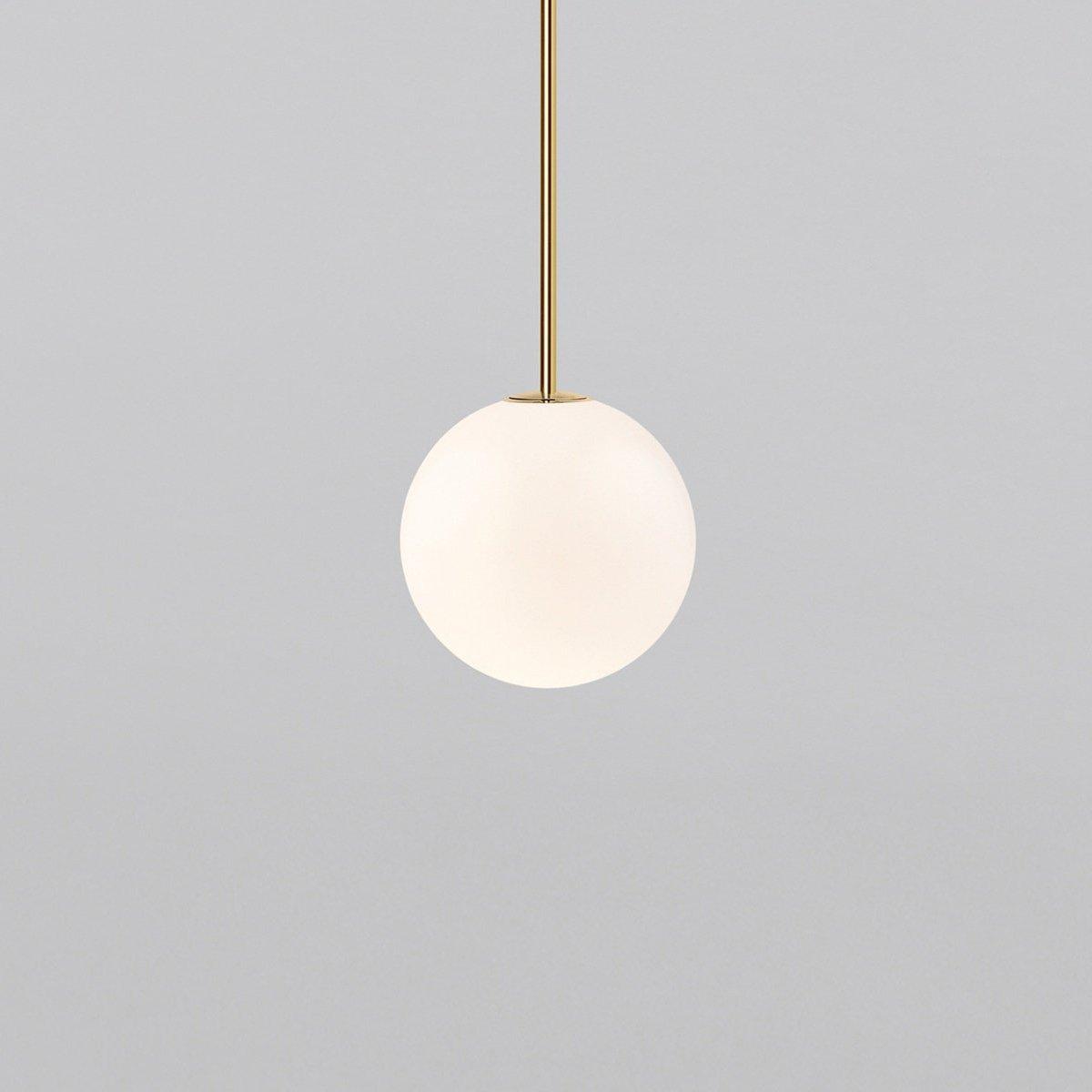 White opal glass globe pendant light on a slim brass rod