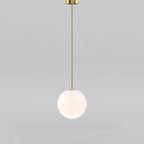 White opal glass globe pendant glowing in a dim room