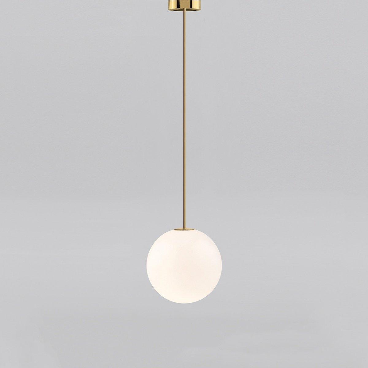White opal glass globe pendant glowing in a dim room