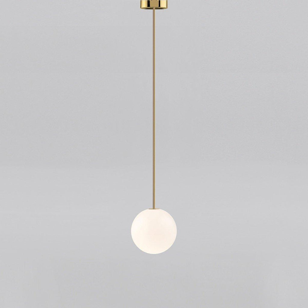 White opal glass globe pendant against a textured wall