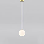 White opal glass globe pendant against a textured wall
